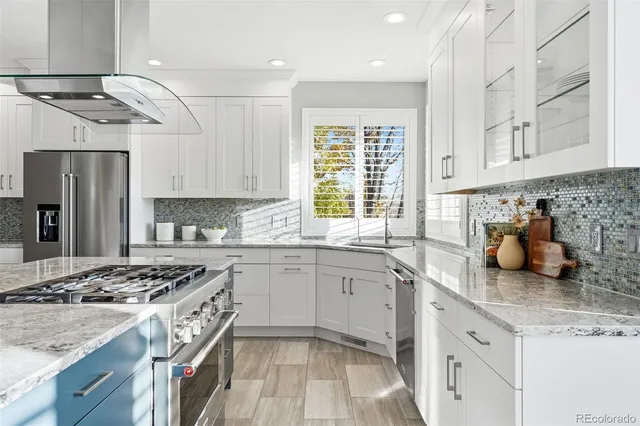 a kitchen with refrigerator a sink and wooden cabinets