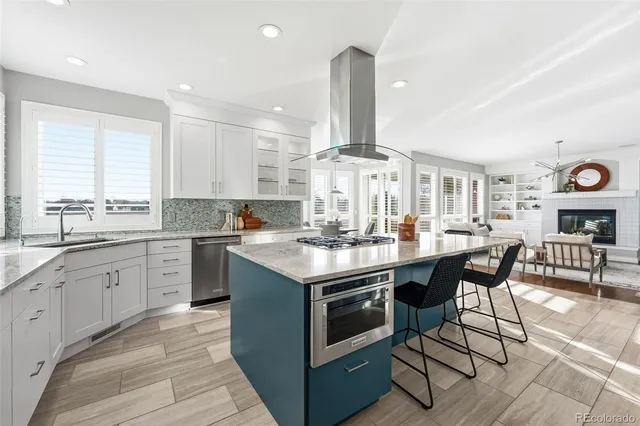 a kitchen with stainless steel appliances granite countertop a refrigerator sink and stove