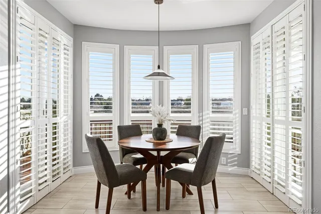 a living room with furniture a fireplace and a large window