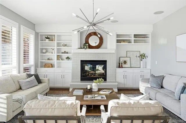 a living room with furniture a table and a fireplace