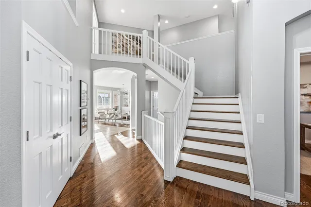 a spacious bedroom with a bed a table and chair