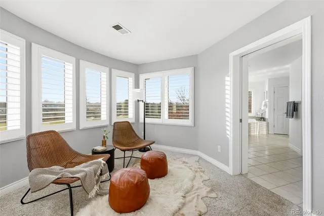 a spacious bathroom with a double vanity sink a mirror a bathtub and next to a window