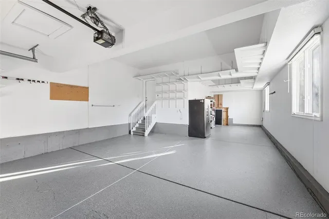 a view of a swimming pool and lounge chairs in back yard of the house