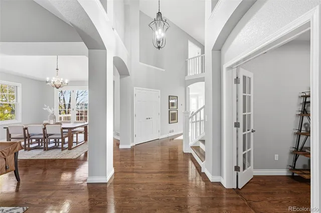 a dining room with wooden floor and large window