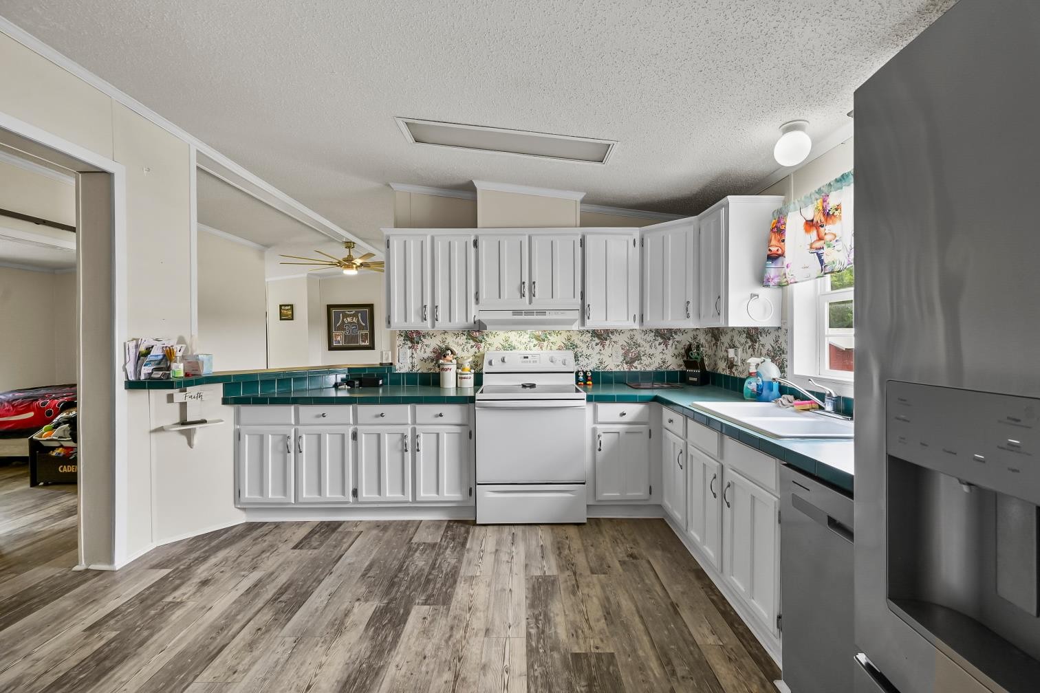 6439 Cedar Grove Road Big Sandy, TN 38221 - Photo 8 of 38 a kitchen with granite countertop white cabinets and white appliances
