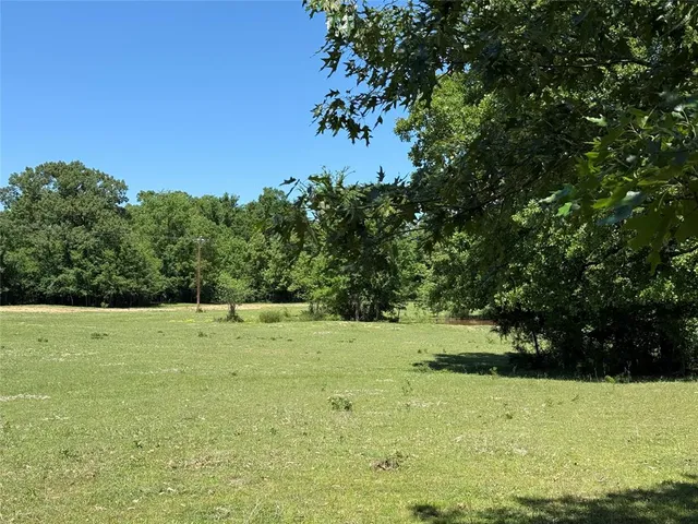 a view of a street with trees on both side of it