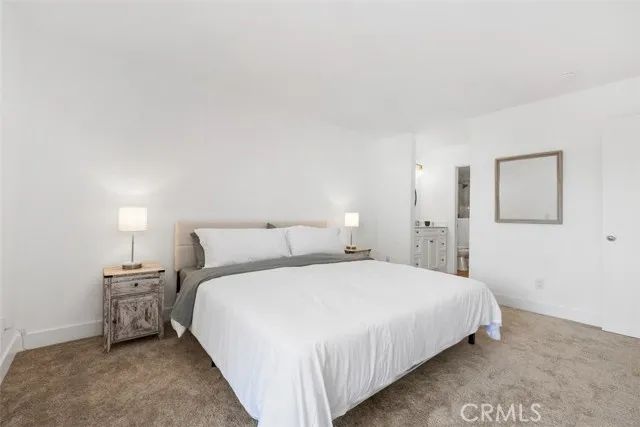 a bedroom with a bed and a night stand