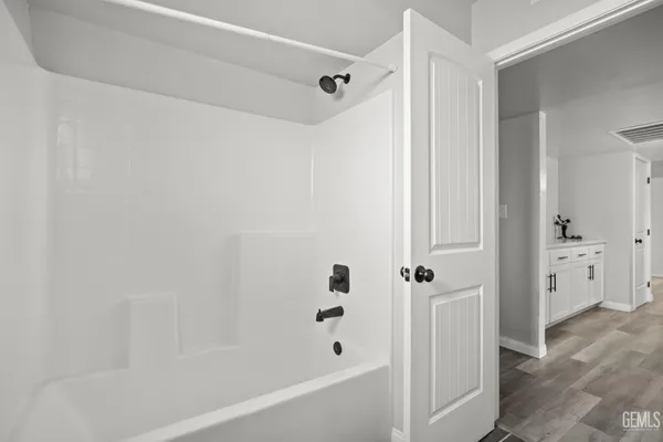 a bathroom with a bathtub and a shower