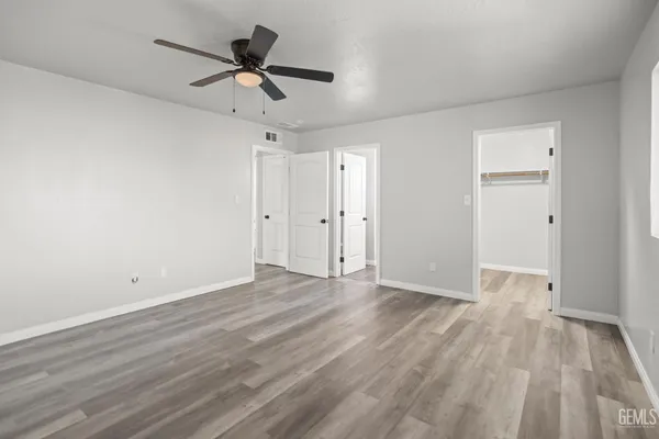 a view of empty room with wooden floor