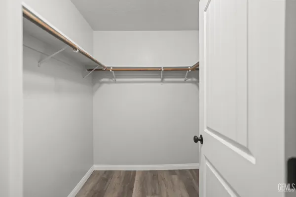 a view of walk in closet with empty racks