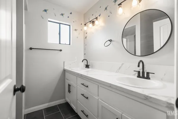 a bathroom with a double vanity sink and mirror