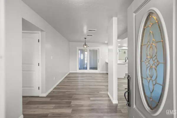 a view of a hallway with windows and bathroom