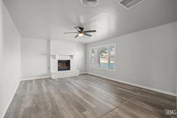 wooden floor in an empty room with a fireplace