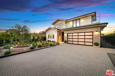 a front view of a house with a garage