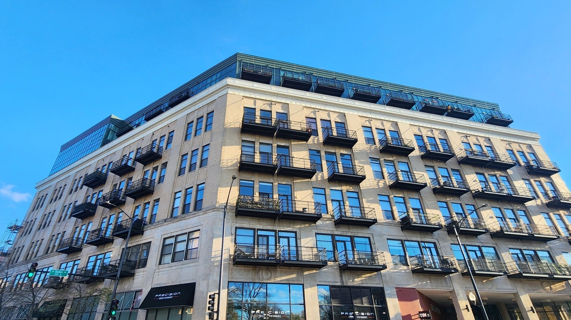 1645 West Ogden Avenue, Unit 417 Chicago, IL 60612 - Photo 1 of 19 a front view of a building with balcony and large windows