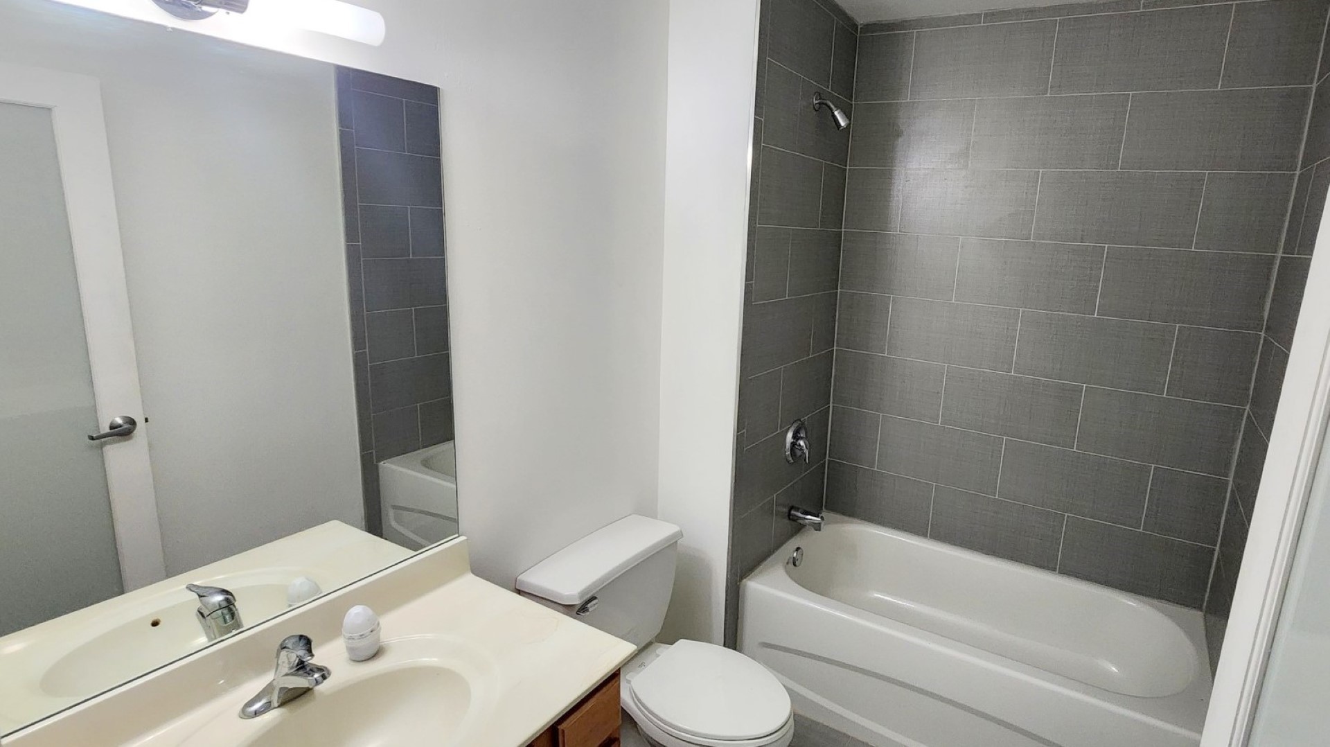 1645 West Ogden Avenue, Unit 417 Chicago, IL 60612 - Photo 12 of 19 a bathroom with a bathtub shower sink vanity and toilet