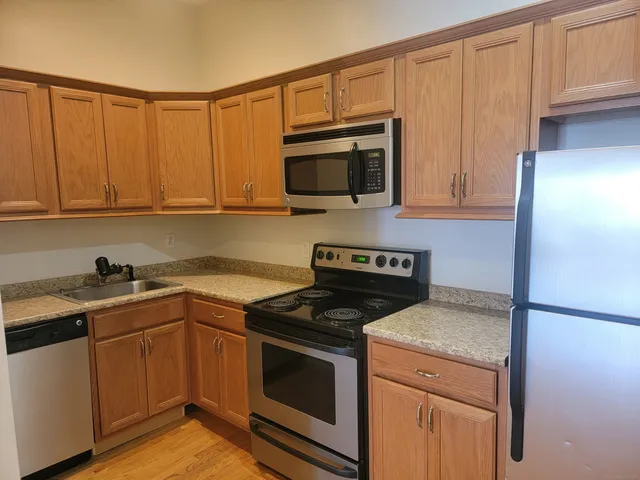 a kitchen with a sink stove and microwave