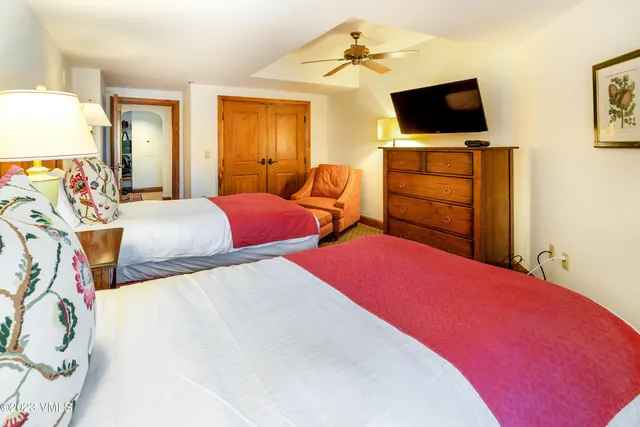 a bedroom with a bed and flat screen tv