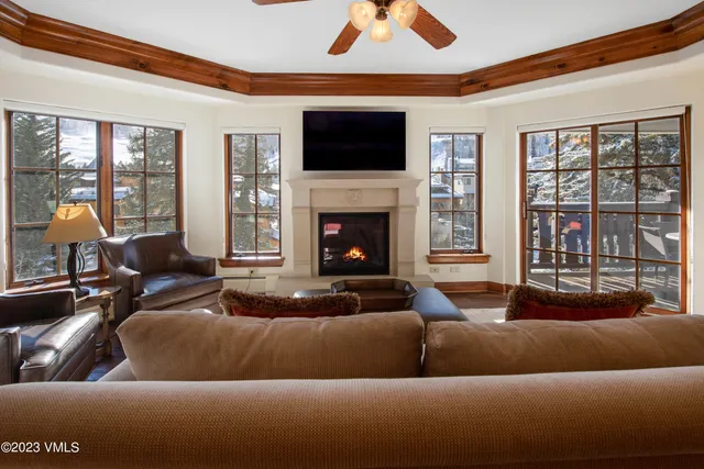 a living room with furniture a fireplace and a flat screen tv