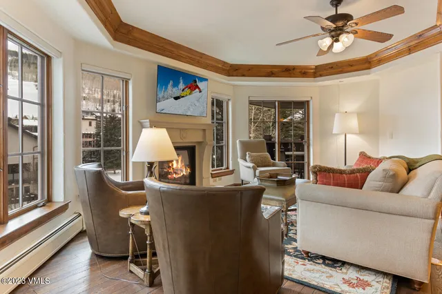 a dining room with furniture a chandelier and wooden floor