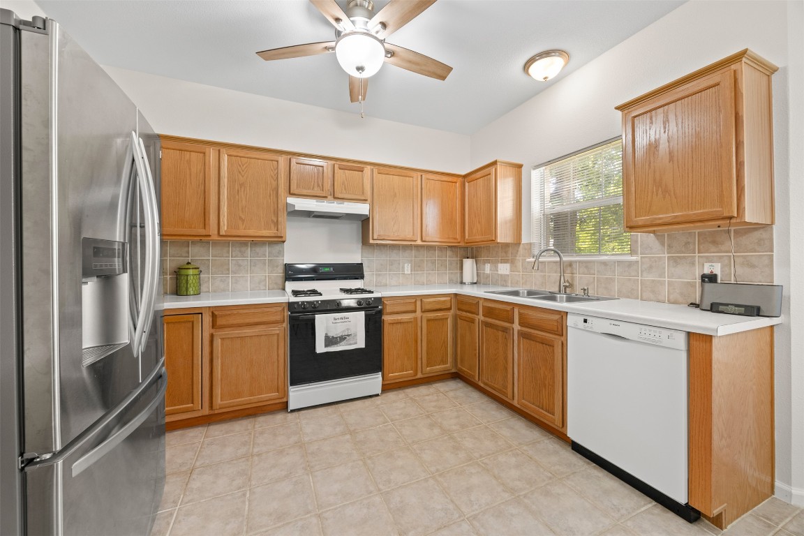 803 North Myrtle Street Georgetown, TX 78626 - Photo 14 of 40 Kitchen featuring stainless steel fridge with ice dispenser, dishwasher, range with gas cooktop, under cabinet range hood, and ceiling fan