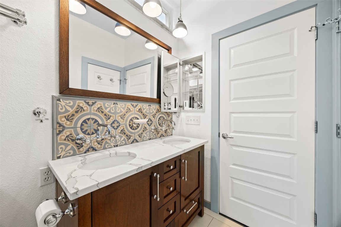 803 North Myrtle Street Georgetown, TX 78626 - Photo 22 of 40 Bathroom with decorative backsplash, double vanity, and tile patterned floors