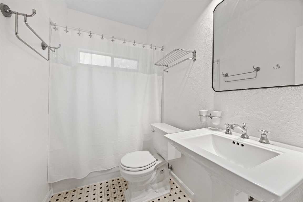 803 North Myrtle Street Georgetown, TX 78626 - Photo 25 of 40 Bathroom with shower / bath combination with curtain and a textured wall