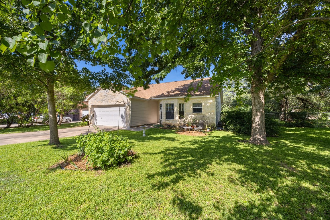 803 North Myrtle Street Georgetown, TX 78626 - Photo 26 of 40 View of front of home with an attached garage, concrete driveway, a front yard, and stone siding