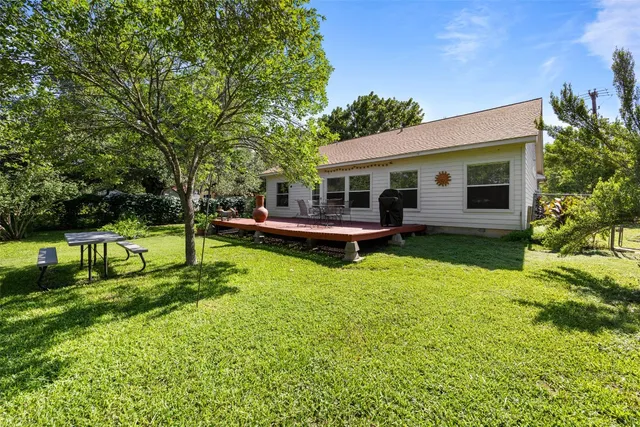 a view of a house with backyard patio and swimming pool