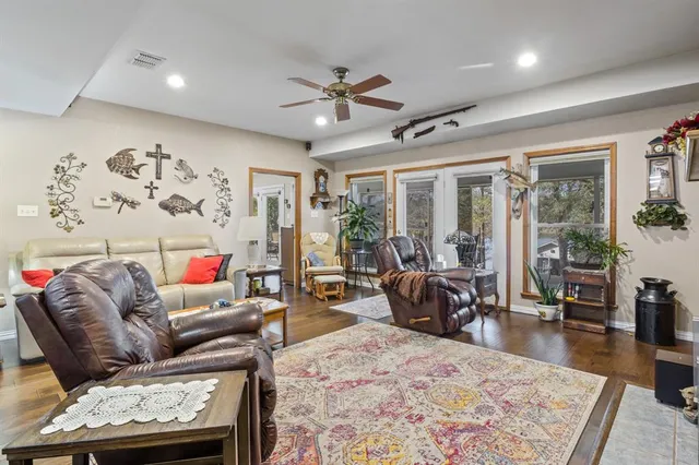a living room with furniture and wooden floor