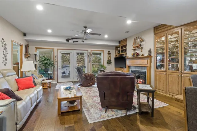 a living room with furniture fireplace and a large window