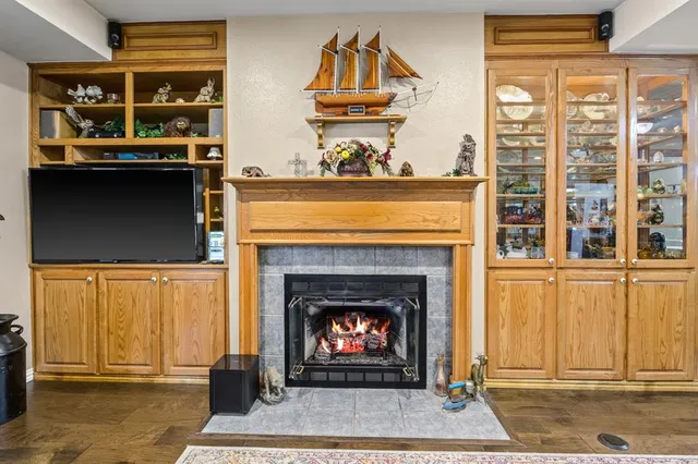 a living room with a fireplace and a window