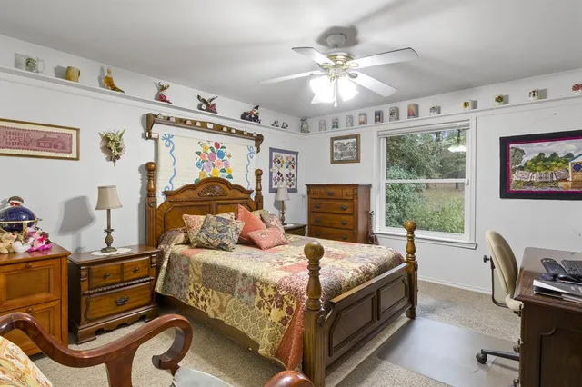 a bedroom with a bed gym equipment and window