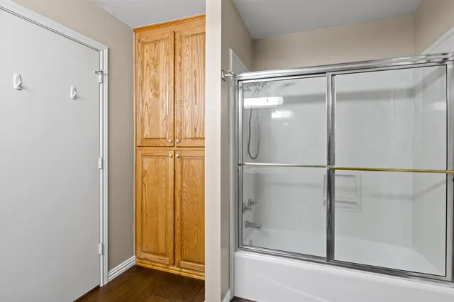a bathroom with a glass shower door