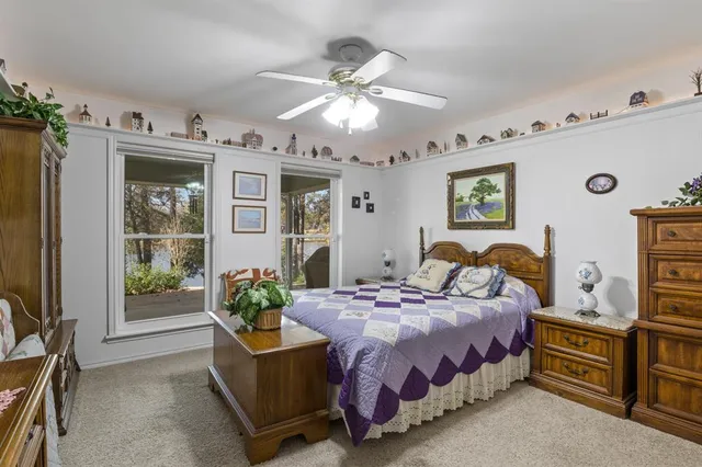 a bedroom with a bed furniture and a flat tv screen
