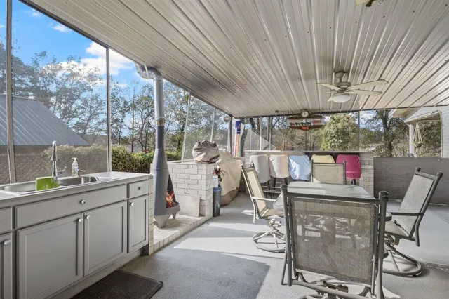 a room with stainless steel appliances kitchen island granite countertop furniture and a large window