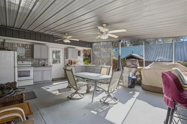 a view of a dining room with furniture and a chandelier