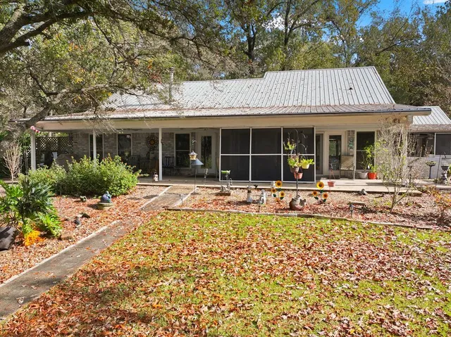 a view of a white house with a large pool and large windows