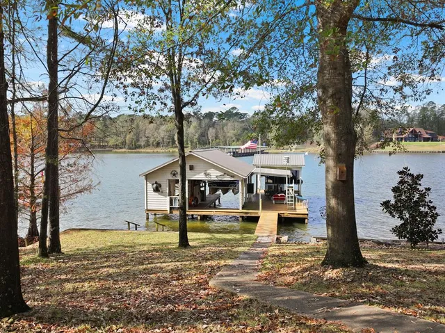 a view of a house with a yard from a large tree