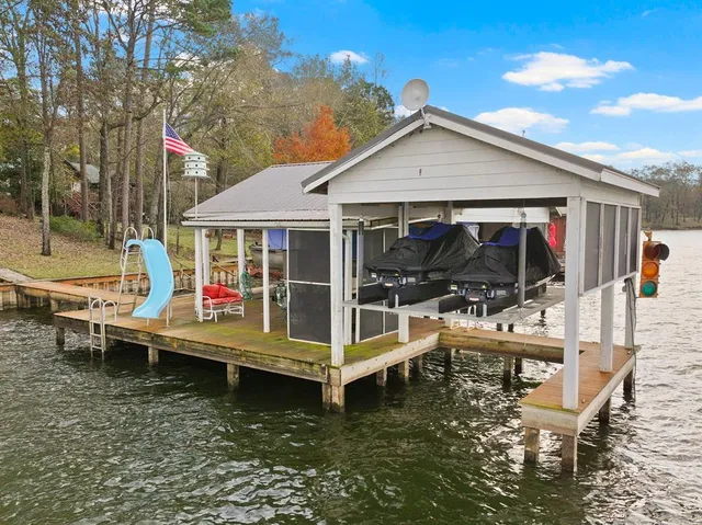 a view of a house with backyard porch and sitting area