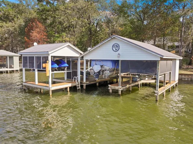 a blue swimming pool is sitting in front of house