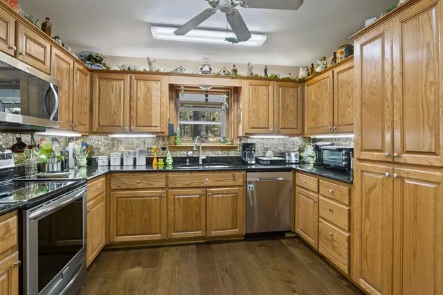 a kitchen with stainless steel appliances a stove sink and cabinets