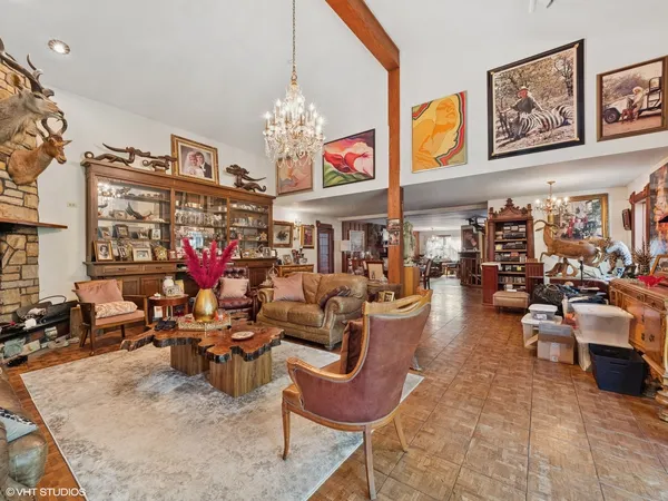 a view of a living room filled with furniture and a chandelier