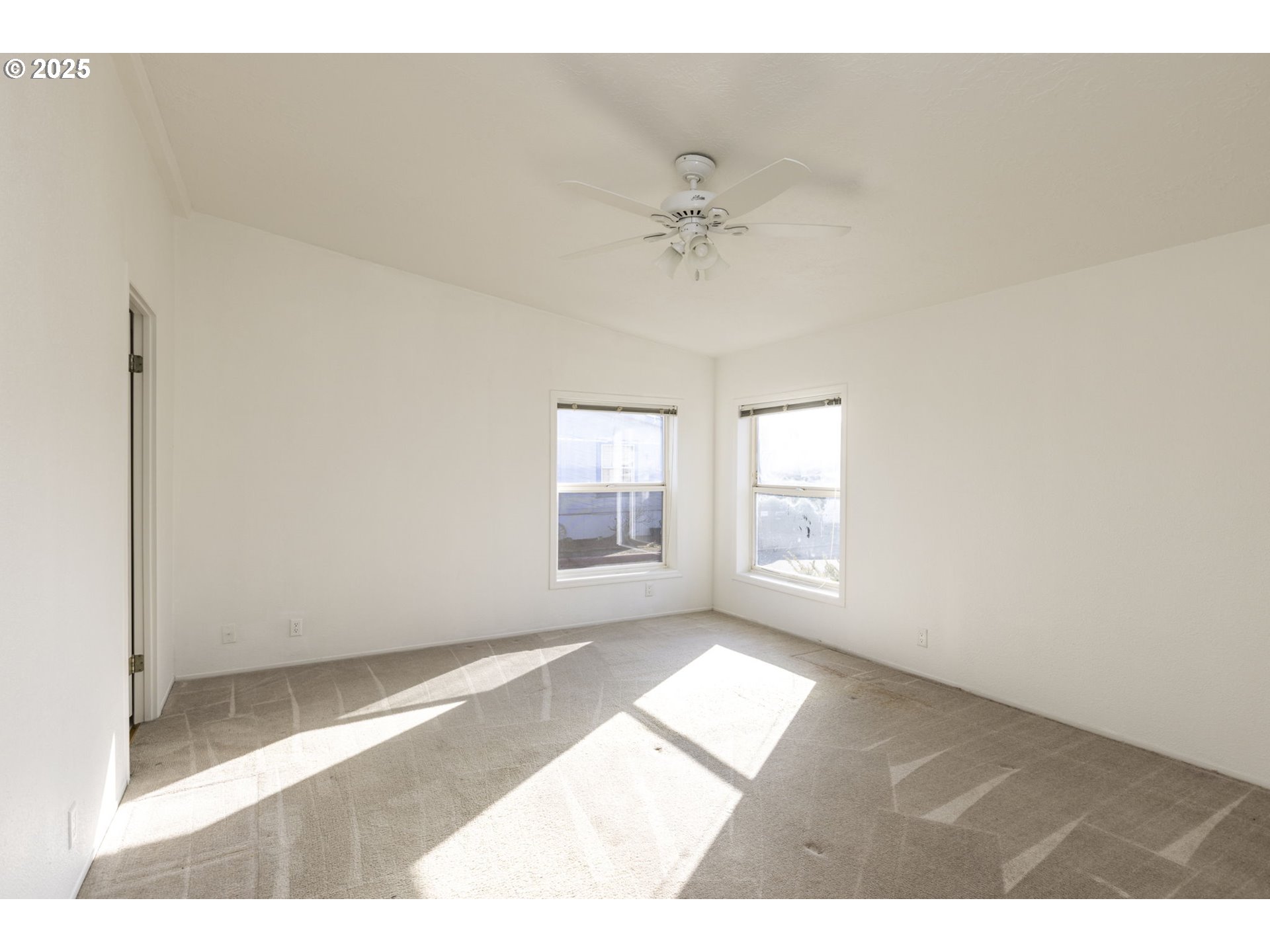 1949 Southeast Palmquist Road, Unit 80 Gresham, OR 97080 - Photo 11 of 35 a view of an empty room with a window