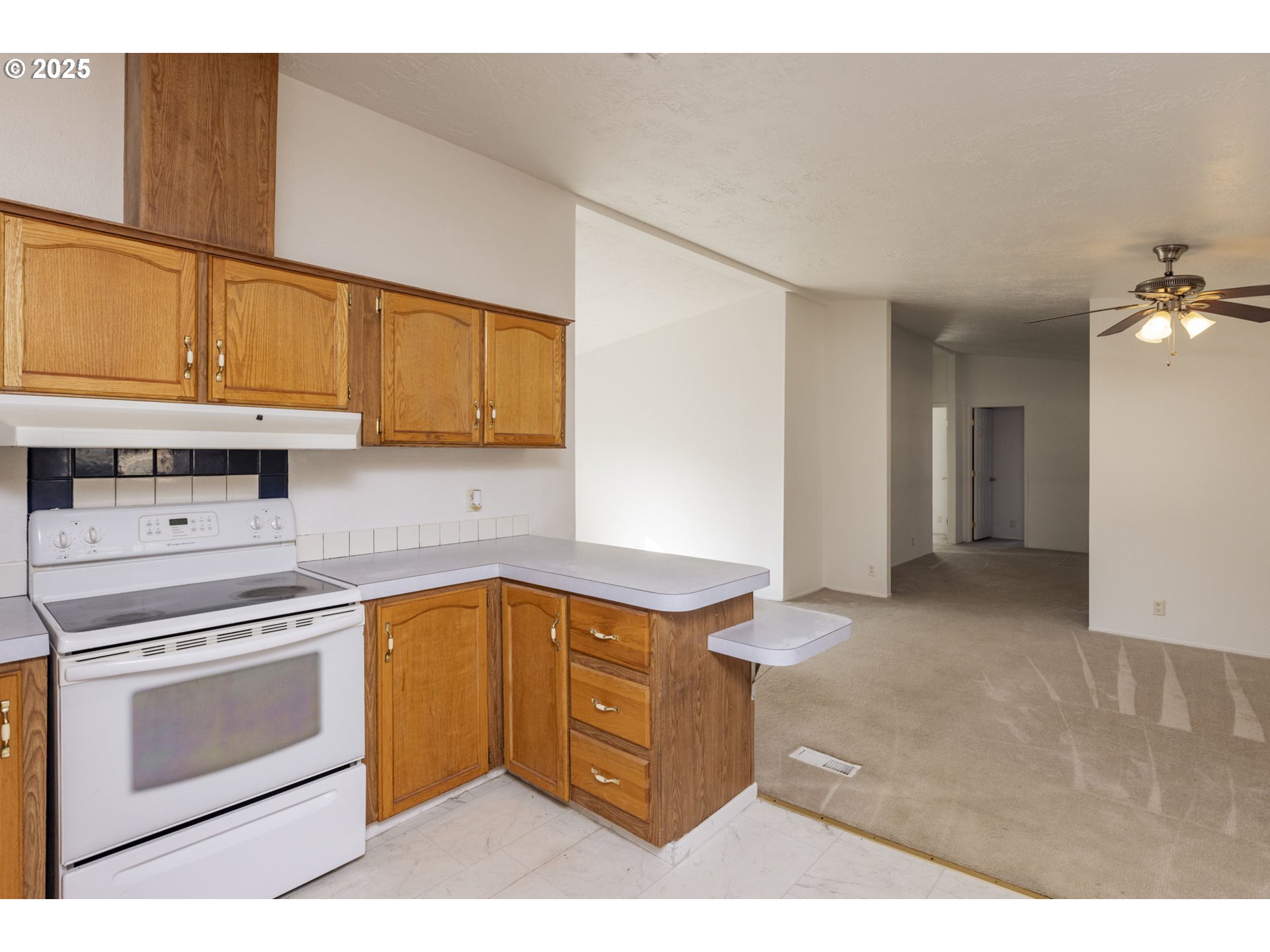 1949 Southeast Palmquist Road, Unit 80 Gresham, OR 97080 - Photo 13 of 35 a kitchen with stainless steel appliances granite countertop a stove a sink and a microwave