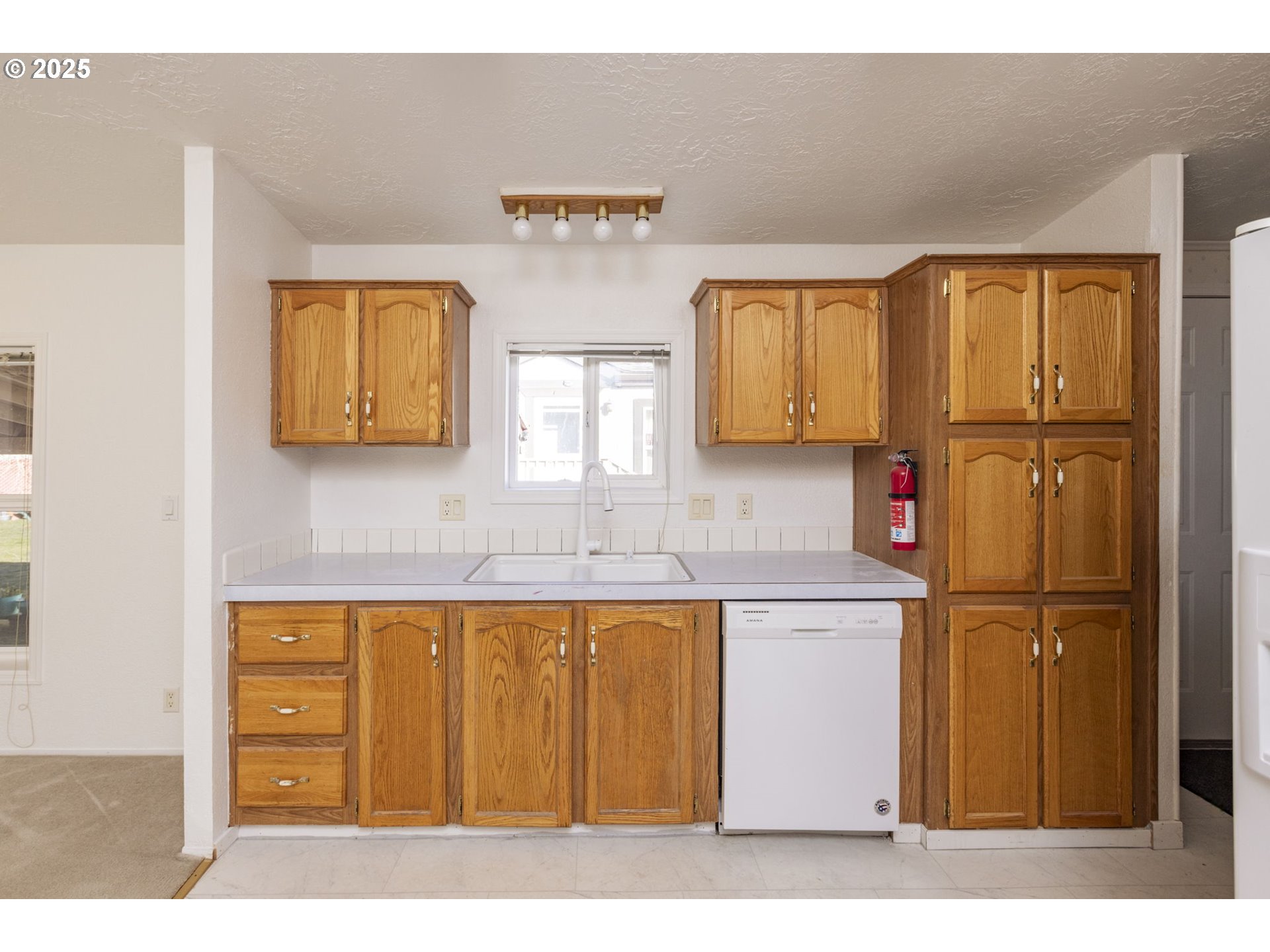 1949 Southeast Palmquist Road, Unit 80 Gresham, OR 97080 - Photo 15 of 35 a kitchen with stainless steel appliances granite countertop a sink and cabinets