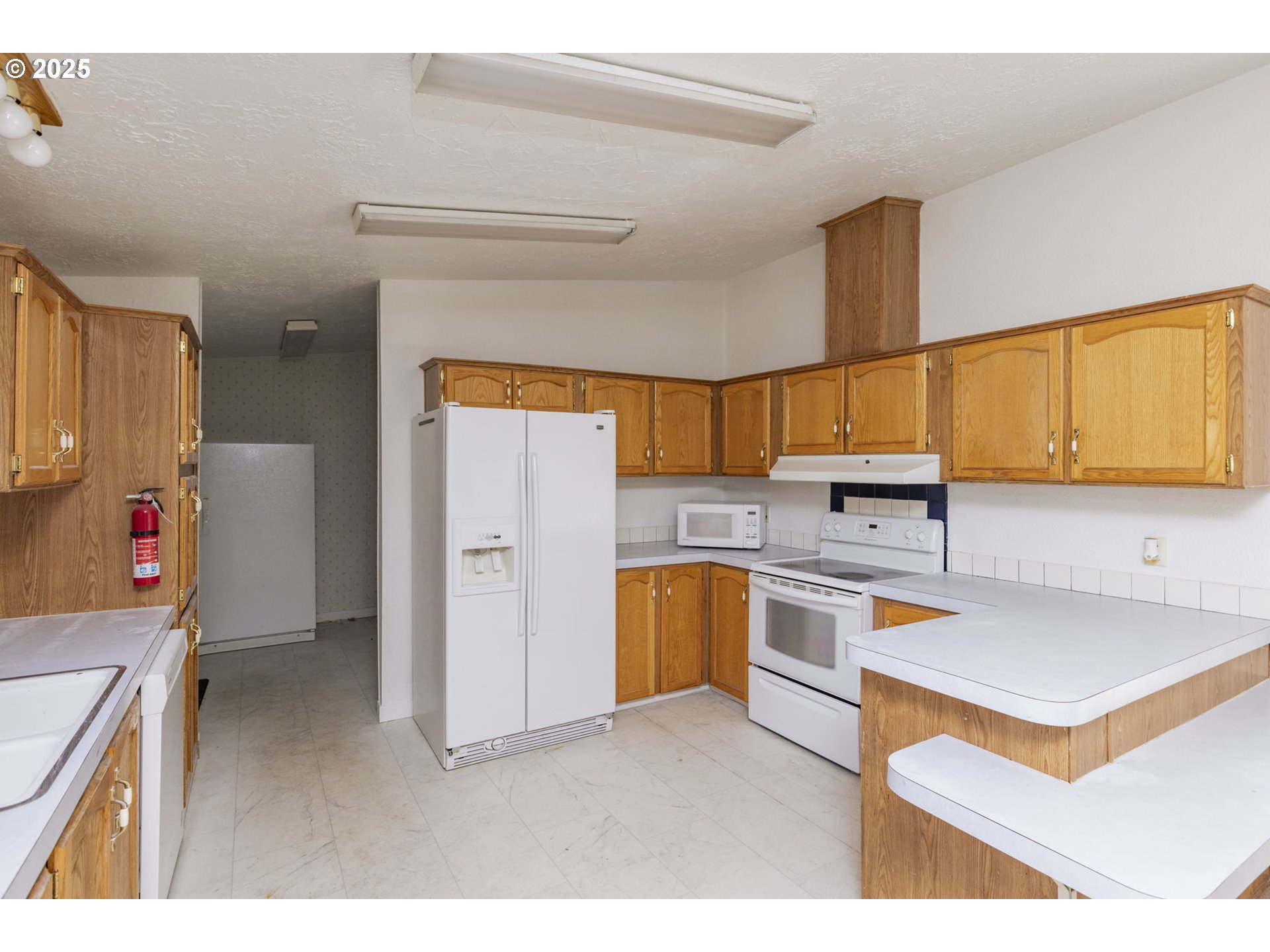1949 Southeast Palmquist Road, Unit 80 Gresham, OR 97080 - Photo 16 of 35 a kitchen with a refrigerator and a sink