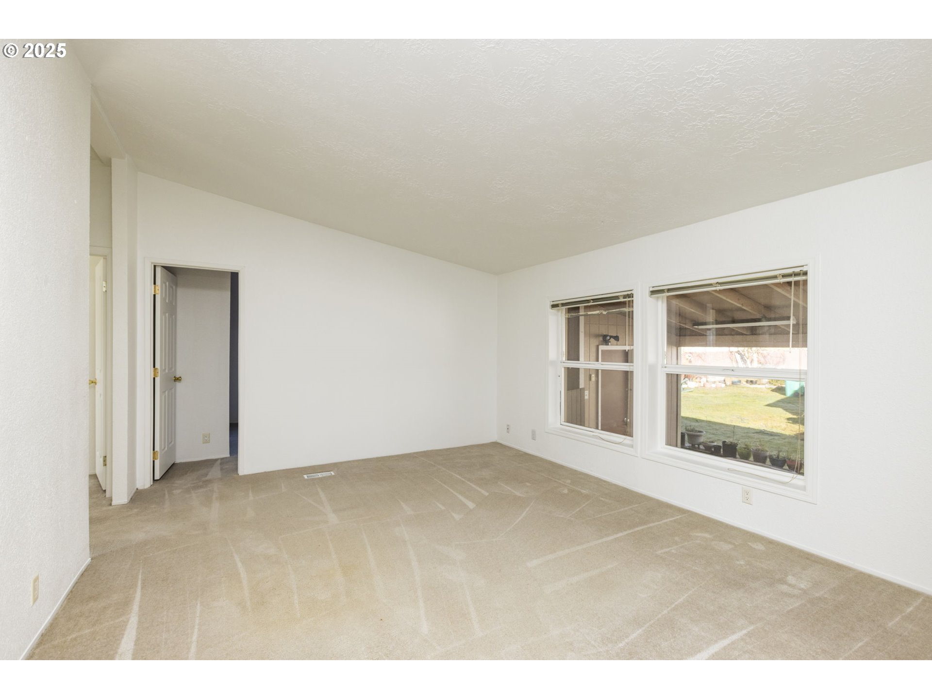 1949 Southeast Palmquist Road, Unit 80 Gresham, OR 97080 - Photo 17 of 35 a view of an empty room with a window