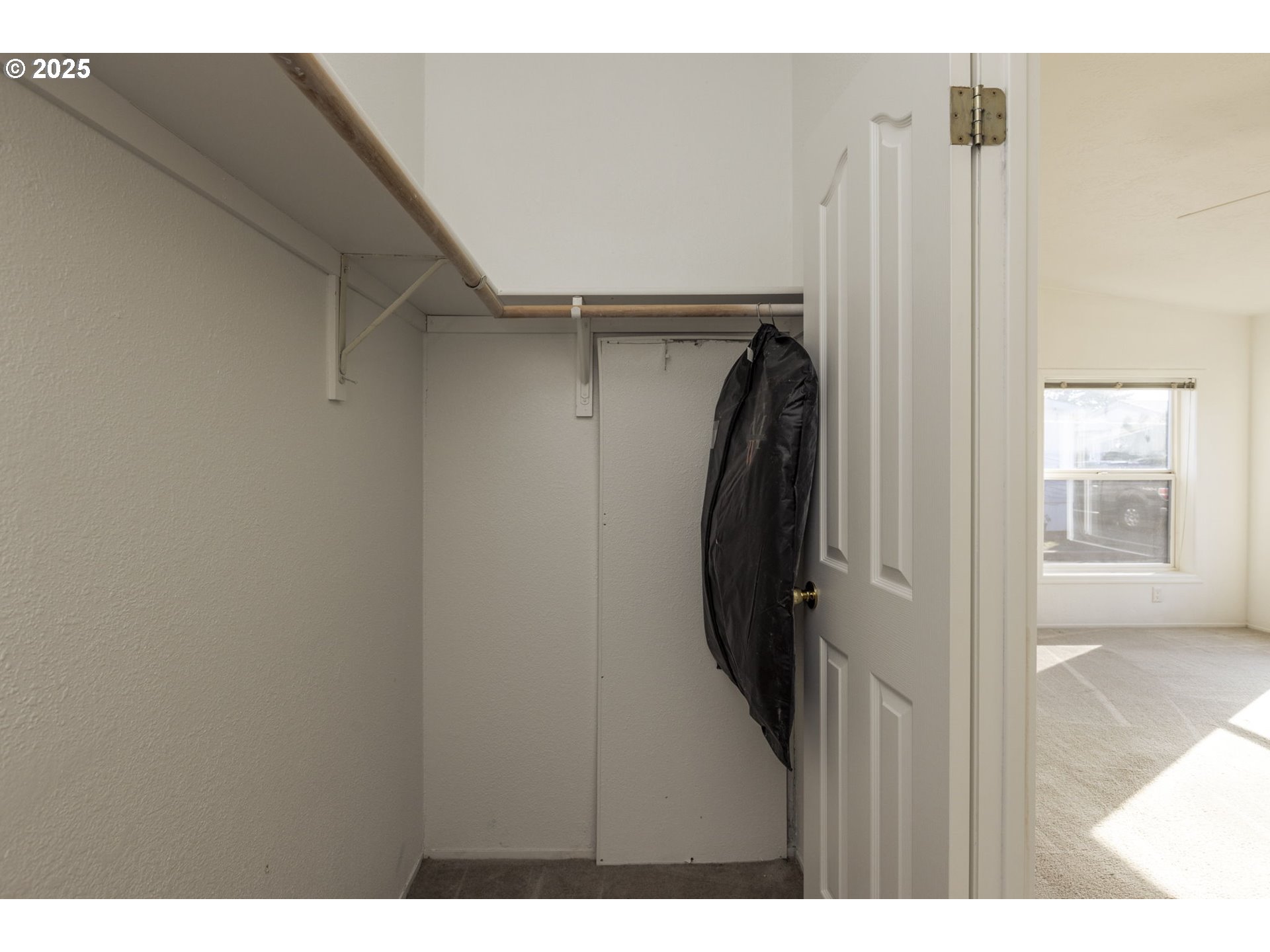 1949 Southeast Palmquist Road, Unit 80 Gresham, OR 97080 - Photo 18 of 35 a view of walk in closet with clothes and shoes