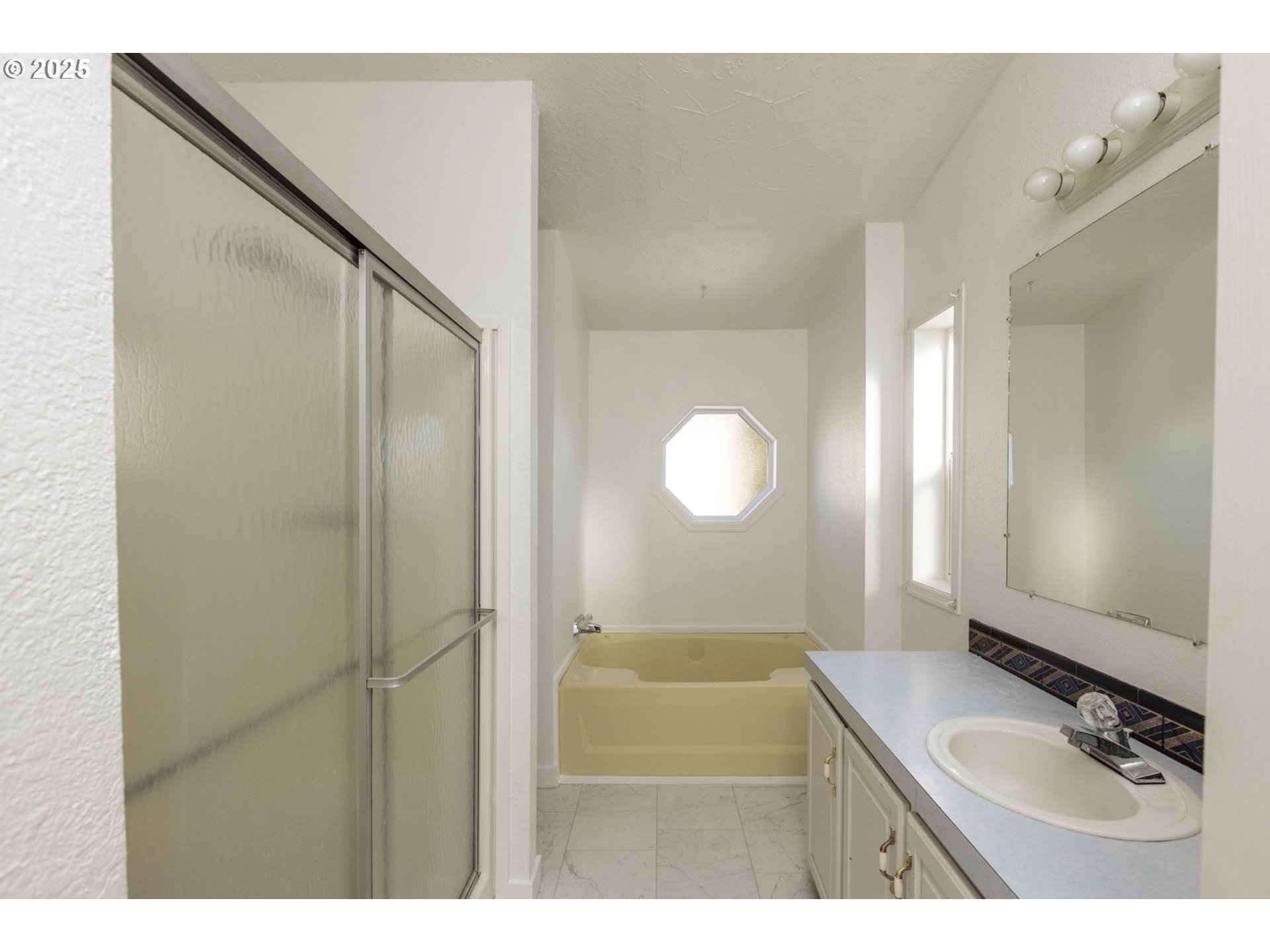 1949 Southeast Palmquist Road, Unit 80 Gresham, OR 97080 - Photo 20 of 35 a bathroom with a sink mirror and a shower